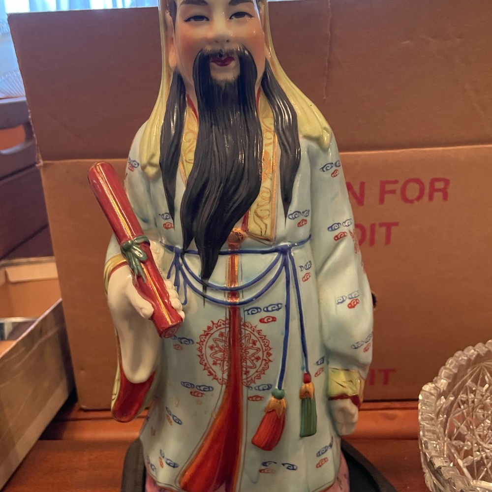 Ceramic Figurine with Scroll and Tassels